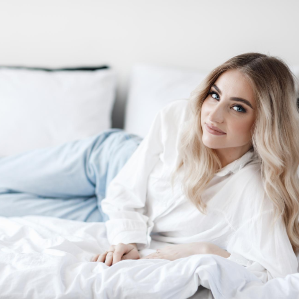 woman lying down on a bed